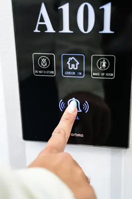a person is pointing at a button on a microwave at Vila Palas in Vrnjačka Banja
