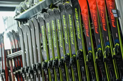 a bunch of skis are lined up on a rack at Apartman La Foresta Kopaonik in Kopaonik