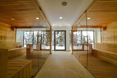 a lobby with glass doors and wood paneled walls at Apartman La Foresta Kopaonik in Kopaonik