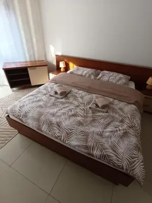 a large bed in a bedroom with at Apartman Romantic in Vrnjačka Banja