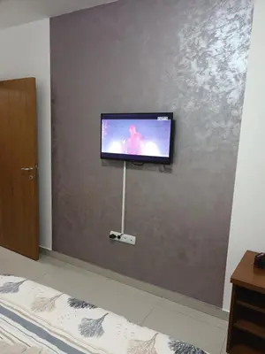 a flat screen tv on a wall in a bedroom at Apartman Romantic in Vrnjačka Banja