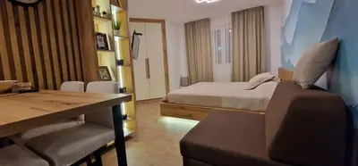 a bedroom with a bed and a table and a chair at CentralKop in Kopaonik