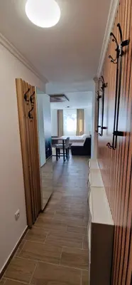 a hallway with a door and a room with a table at CentralKop in Kopaonik