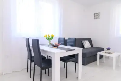 a living room with a table and a couch at Apartman MASTER in Soko Banja