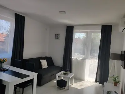 a living room with a couch and a table at Apartman MASTER in Soko Banja