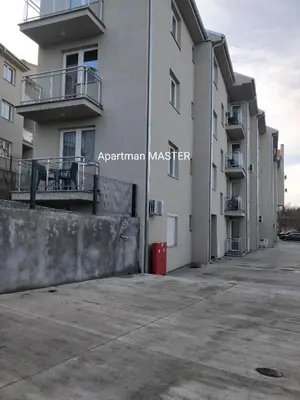 an empty parking lot in front of an apartment building at Apartman MASTER in Soko Banja
