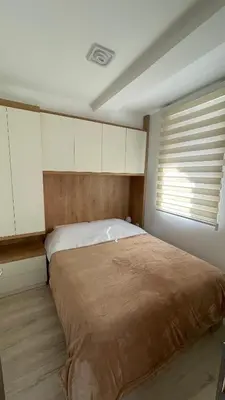 a bedroom with a large bed and a window at Geregs alibi in Kopaonik