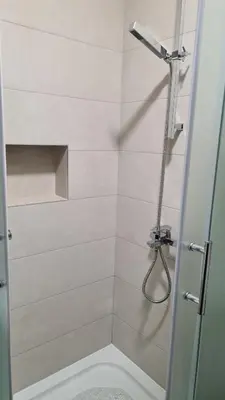 a bathroom with a shower with a toilet at MS Apartman in Vrnjačka Banja