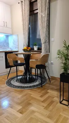 a dining room with a table and chairs in a room at MS Apartman in Vrnjačka Banja