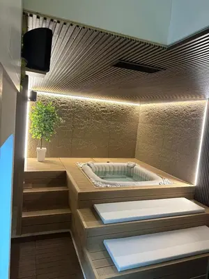 a bathroom with a tub with a potted plant at Gencian resort in Kopaonik