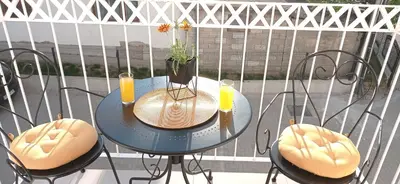 a table with two chairs and two drinks on a balcony at Apartman Vule in Vrnjci