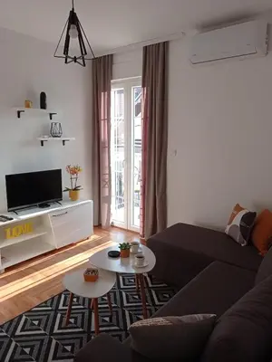 a living room with a couch and a tv at Apartman Vule in Vrnjci