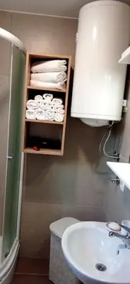 a bathroom with a sink and a toilet and towels at Apartman Vule in Vrnjci
