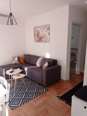 a living room with a couch and a table at Apartman Vule in Vrnjci