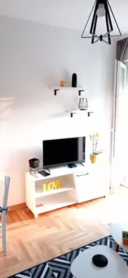 a living room with a tv on a white entertainment center at Apartman Vule in Vrnjci