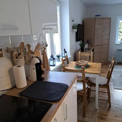 a kitchen and living room with a table and a dining room at A2Kopaonik newly built apartments in Kopaonik