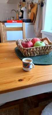 a bowl of apples and a cup of coffee on a table at A2Kopaonik newly built apartments in Kopaonik