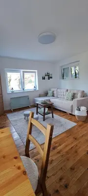 a living room with a couch and a table at A2Kopaonik newly built apartments in Kopaonik