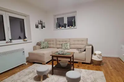a living room with a couch and a table at A2Kopaonik newly built apartments in Kopaonik
