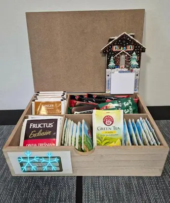 a wooden box filled with gifts and a toy house at Apartman BM403 in Kopaonik