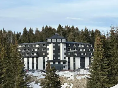 a large building in the middle of a forest at Apartman BM403 in Kopaonik