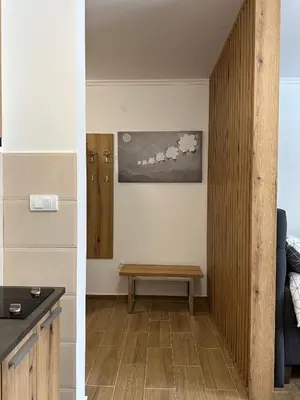 a living room with a bench and a table at Apartman BM403 in Kopaonik