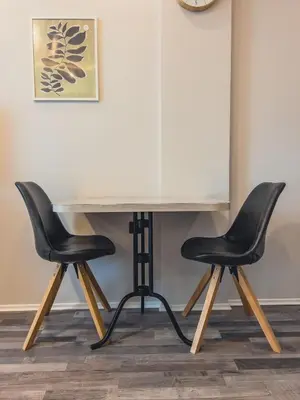 two black chairs sitting next to a white table at Milmari Premier - Daisy Apartments in Kopaonik