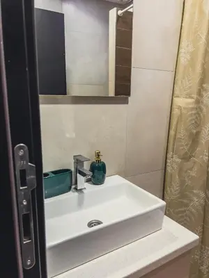 a white sink in a bathroom with a mirror at Milmari Premier - Daisy Apartments in Kopaonik