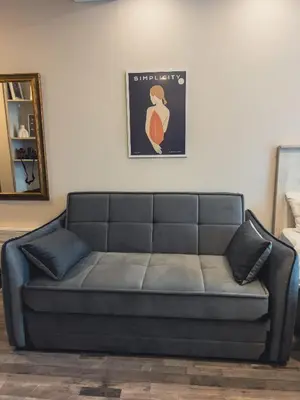 a gray couch in a living room with a mirror at Milmari Premier - Daisy Apartments in Kopaonik