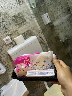 a person holding a tray withiazepam and other items at Apartments PKT DeLux in Niš