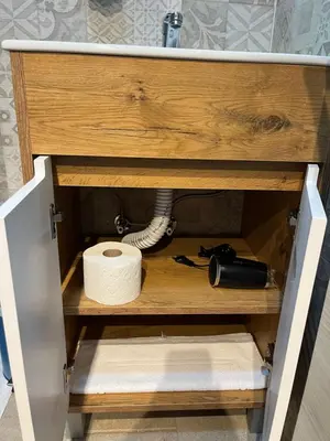 a drawer in a cabinet with a roll of toilet paper at Apartments PKT DeLux in Niš