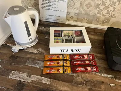 a tea box sitting on the floor next to a coffee maker at Apartments PKT DeLux in Niš