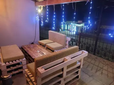 a room with a couch and a table and lights at Apartments PKT DeLux in Niš
