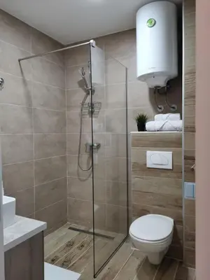 a bathroom with a shower with a toilet and a sink at Talija Milmari Nlux in Kopaonik