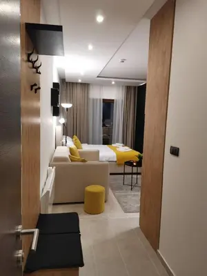 a hotel room with a bed and a couch at Talija Milmari Nlux in Kopaonik