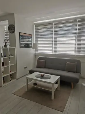 a living room with a couch and a coffee table at Quince in Bor