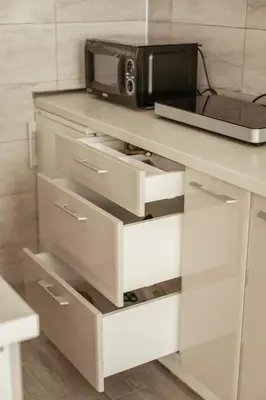 a microwave sitting on top of a counter with drawers at Quince in Bor
