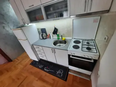 a small kitchen with a stove and a sink at Victory apartment in Niš