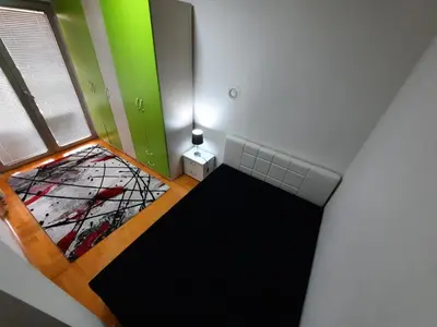 an attic room with a stained glass window at Victory apartment in Niš