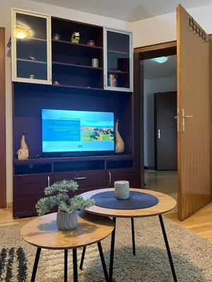 a living room with a coffee table and a tv at Apartman Danica in Vrnjačka Banja