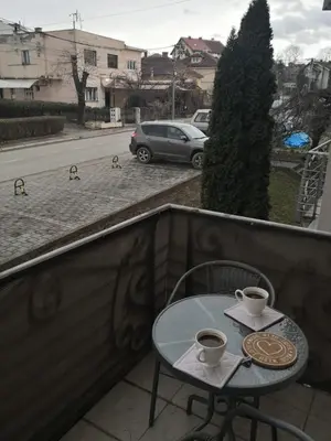 a table and two cups of coffee on a balcony at Apartman Danica in Vrnjačka Banja