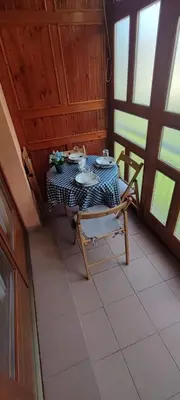 a table and a chair in a room with a table and chairsktop at Marina in Vrnjačka Banja