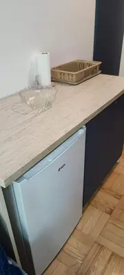 a kitchen counter with a white dishwasher under a counter at Marina in Vrnjačka Banja