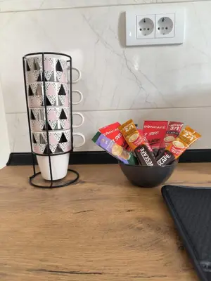 a bowl of snacks on a table next to a lamp at Apartman Nađa in Soko Banja