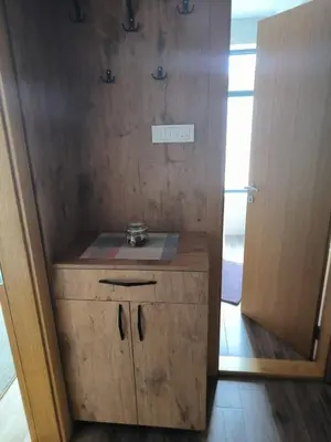 a wooden cabinet with a sink in a room at Apartman Nađa in Soko Banja