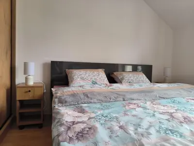 a bedroom with two beds and a night stand at Apartman Nađa in Soko Banja