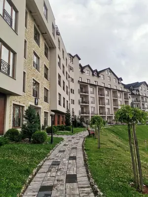 a path in front of a large building at Golden view apartment P82 - Milmari Apartments & SPA in Kopaonik