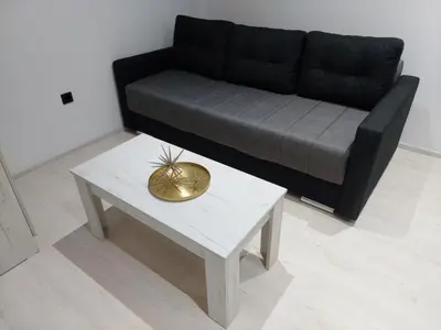 a living room with a couch and a table at Apartman Aleksić u centru grada in Knjazevac.