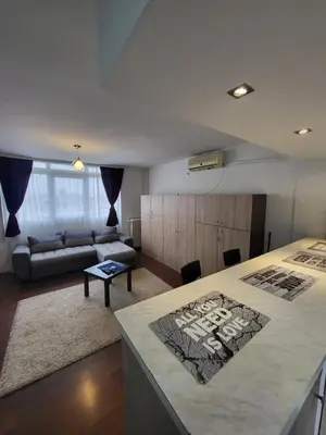 a living room with a bed and a couch at Apartman Nina in Niš