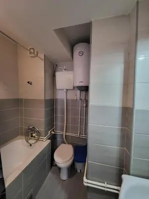 a bathroom with a toilet and a tub and a sink at Apartman Nina in Niš